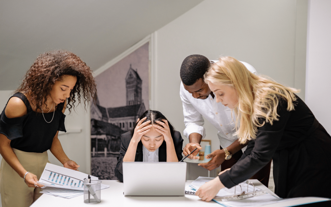 Employees in an office environment with an atmosphere of tension or conflict illustrating workplace Harassment